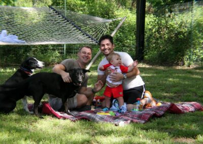 Hodgkinson-soto family relaxing on the grass with their two dogs